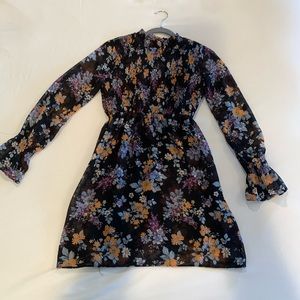 Black floral dress. Smocked top, sheer with black lining.